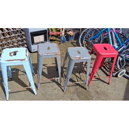 660 - Set of four vintage industrial metal stools in mixed colors.