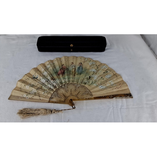 1192 - Hand-painted folding fan with floral and figure motifs. Delicate lace trim and accompanied by a blac... 