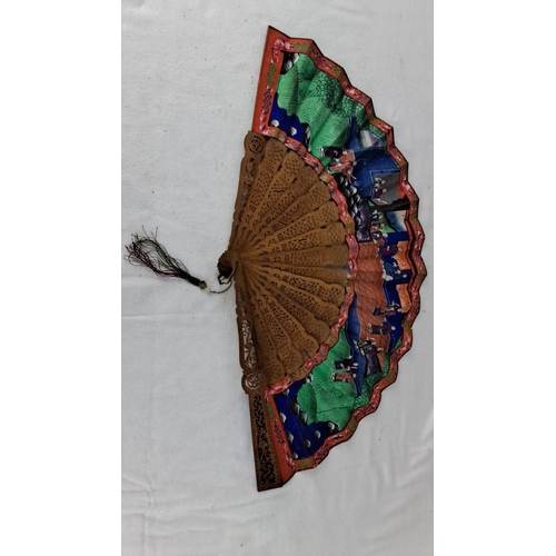 1194 - Carved wooden oriental hand fan with colorful painted scenes. Includes traditional figures and lands... 