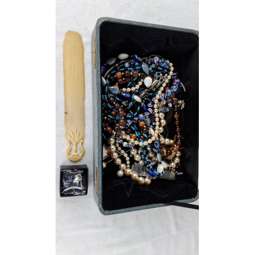 1198 - Assorted costume jewelry includes pearl and bead necklaces, all stored in a fabric-lined jewelry box... 