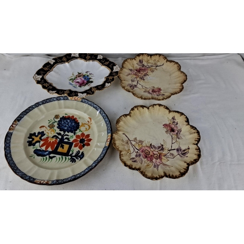 1203 - Set of four decorative floral plates with hand-painted designs. Scalloped and patterned edges that i... 