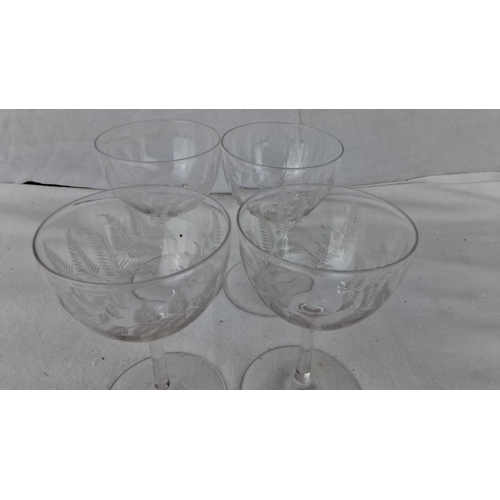 1206 - Set of four etched glass champagne coupes with fern motif detailing.