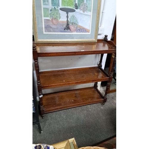 1212 - Three-tiered wooden shelves with turned legs, likely made of mahogany. Features a classic design. Di... 