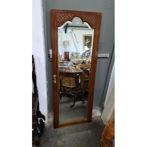 1214 - Victorian mahogany framed mirror with carved geometric design, brass escutcheon, and beveled glass. ... 