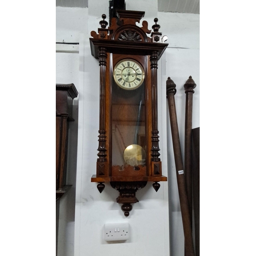 1225 - Late 19th Century Victorian wall clock in a mahogany case, featuring a decorative pediment, fluted c... 