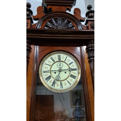 1225 - Late 19th Century Victorian wall clock in a mahogany case, featuring a decorative pediment, fluted c... 