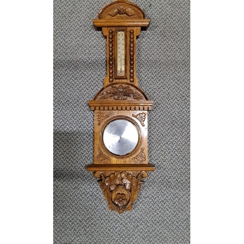 1228 - Victorian-era oak barometer with carved floral motifs. It features a thermometer with both Celsius a... 