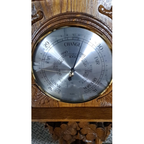 1228 - Victorian-era oak barometer with carved floral motifs. It features a thermometer with both Celsius a... 