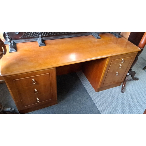 1238 - Mid-Century Modern wooden desk with six drawers, showcasing a warm finish and simple, sleek lines ty... 