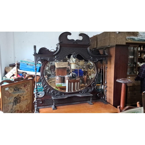 1239 - Victorian dark wood overmantel mirror with ornate carvings and a central oval glass. Approximately l... 