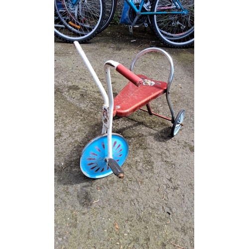 652 - Vintage tricycle featuring a red steel frame with blue wheels and white handlebars. Includes retro g... 