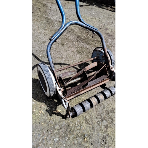 659 - Vintage manual lawn mower with blue metal frame and cylindrical blade reel. Features large grooved w... 