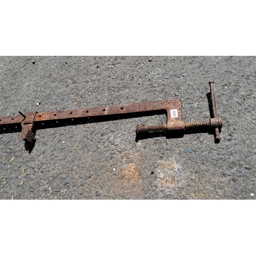 665 - Vintage metal bar clamp with adjustable screw mechanism and multiple positioning holes.