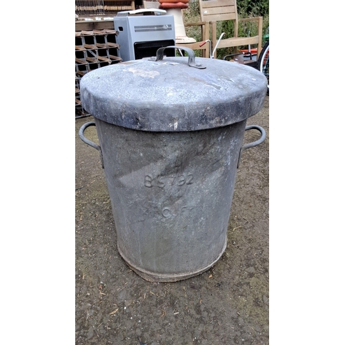 667 - Vintage galvanized metal trash can with lid, featuring dual side handles. Stamped with 