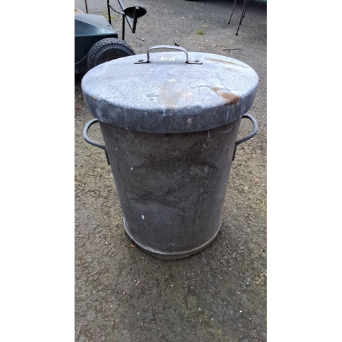 667 - Vintage galvanized metal trash can with lid, featuring dual side handles. Stamped with 