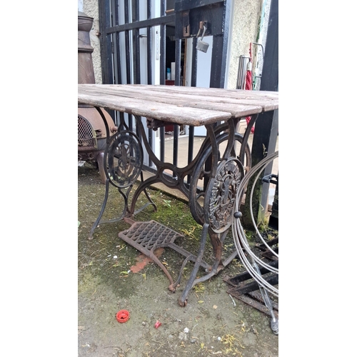 668 - Antique treadle Singer sewing machine table, now a rustic wooden table. Iron base with intricate det... 