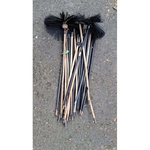 670 - Collection of chimney sweep brushes. Includes approximately 16 wooden and metal-handled brushes, fea... 