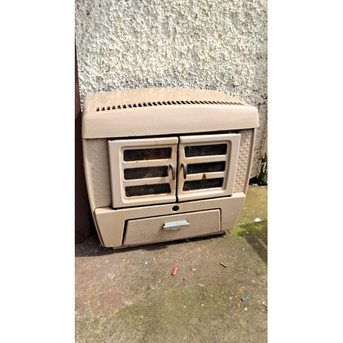 674 - Vintage Cast Iron Gas Heater. Features dual front glass doors and lower ash drawer.