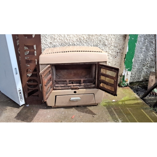 674 - Vintage Cast Iron Gas Heater. Features dual front glass doors and lower ash drawer.