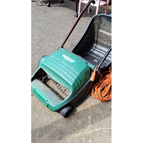 675 - Qualcast electric lawn mower with grass collection box and long extension cord.