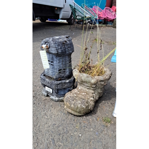 676 - Pair of charming stone planters, one shaped as Windy Miller windmill, the other as a whimsical boot.