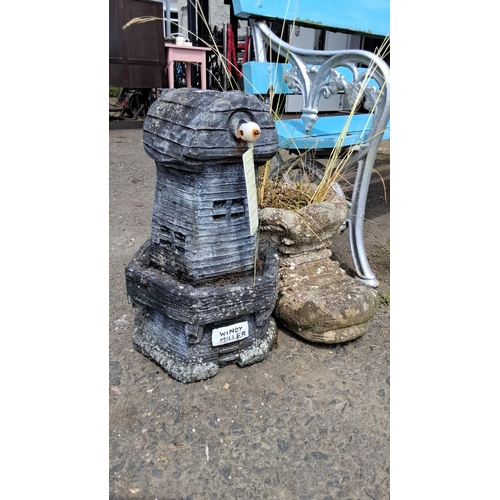 676 - Pair of charming stone planters, one shaped as Windy Miller windmill, the other as a whimsical boot.