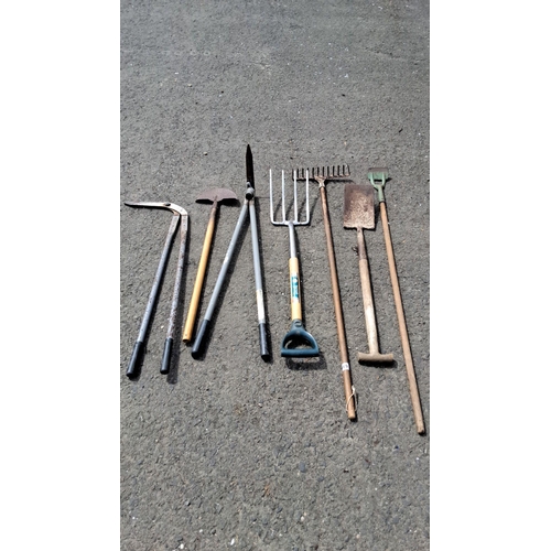 684 - Mixed lot of eight gardening tools. Includes a weed cutter, hoe, cultivator, shovel, spade, pitchfor... 