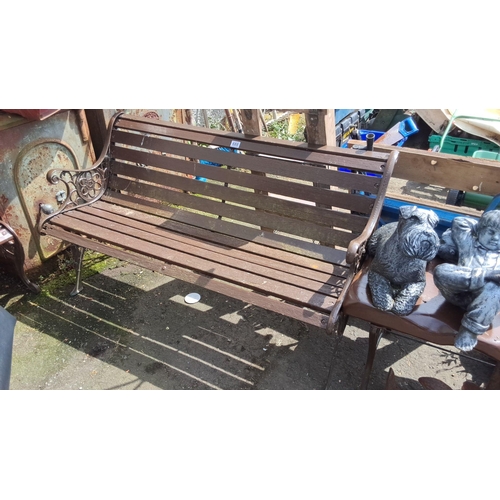 688 - Vintage wooden garden bench with ornate cast iron arms and legs. Sturdy slatted seat design. Comes w... 