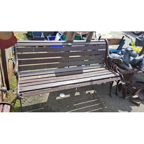 688 - Vintage wooden garden bench with ornate cast iron arms and legs. Sturdy slatted seat design. Comes w... 