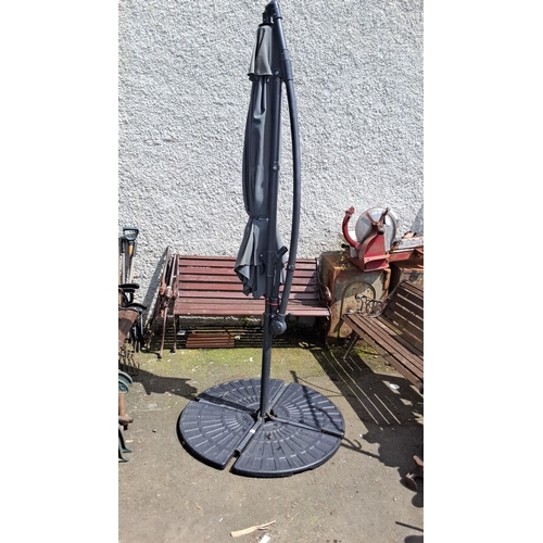 689 - Black outdoor patio umbrella with a sturdy base. It features an adjustable stand and a protective co... 