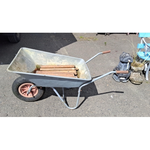 696 - Galvanized steel wheelbarrow with rubber hand grips and pneumatic tire, includes wooden dowels.