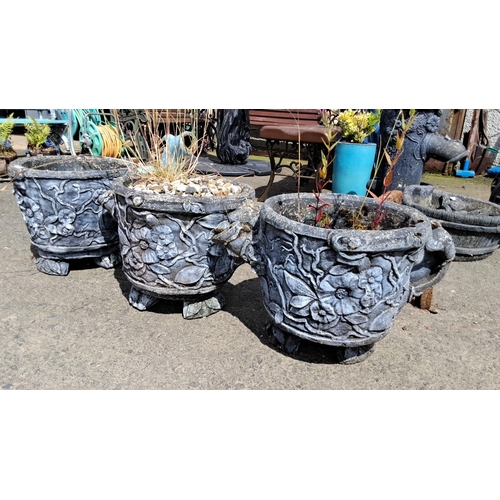 698 - Set of three intricately carved stone planters with floral motifs. Each planter sits on four decorat... 