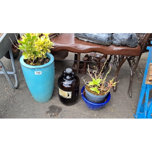 700 - a large turquoise ceramic planter, an amber glass demi john bottle, and a blue planter.