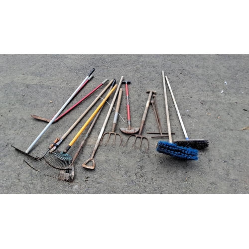 706 - Collection of 11 assorted garden tools including rakes, pitchforks, hoes, and brooms. Handled with s... 