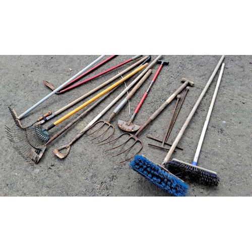 706 - Collection of 11 assorted garden tools including rakes, pitchforks, hoes, and brooms. Handled with s... 