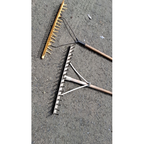 707 - Pair of garden rakes with wooden handles. One rake has metal tines, the other one has yellow plastic... 