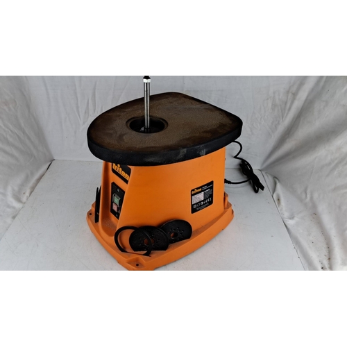 726 - Triton spindle sander, model TSPST450. Distinctive orange casing with sanding accessories included. ... 