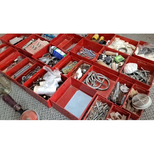 733 - Assorted hardware in red compartments. The set consists of nails, screws, fasteners, latches, and va... 