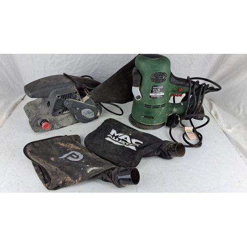 743 - Parkside PES 600 B2 600W orbital sander, brown belt sander, and two dust collection bags.