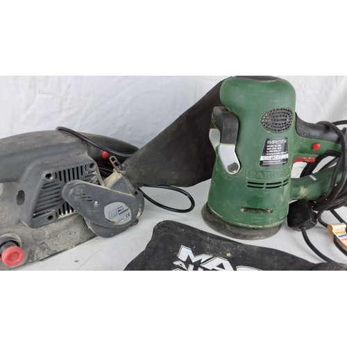 743 - Parkside PES 600 B2 600W orbital sander, brown belt sander, and two dust collection bags.