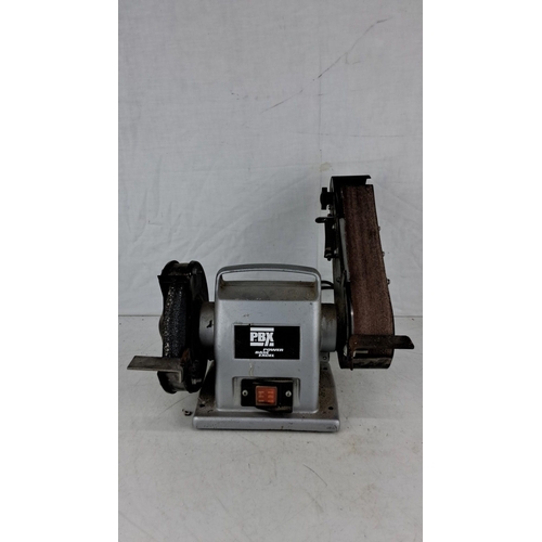 744 - Power Base Excel bench grinder with attached belt sander. Includes a grinding wheel and abrasive bel... 