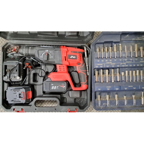 764 - Cordless hammer drill with 88V battery. Includes a charging station and an extensive bit set in a se... 