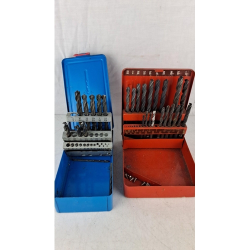 766 - Two drill bit sets in metal cases. One set branded 