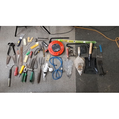 778 - Mixed lot of assorted hand tools. Includes trowels, shears, pliers, measuring tape, and an extension... 