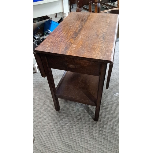 781 - Early 20th-century oak drop-leaf side table with single drawer and lower shelf.