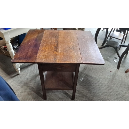 781 - Early 20th-century oak drop-leaf side table with single drawer and lower shelf.