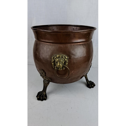 10 - Large Victorian copper cauldron/planter with brass lion head handles and paw feet, circa late 19th c... 