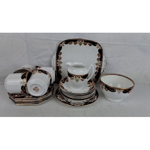 121 - Royal Stafford English bone china tea set with intricate floral and gold detailing. Includes cups, s... 