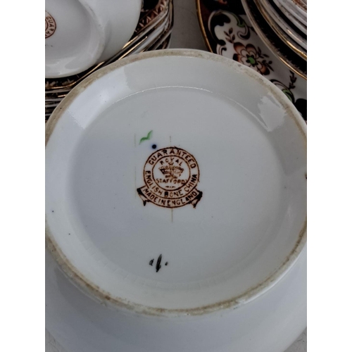 121 - Royal Stafford English bone china tea set with intricate floral and gold detailing. Includes cups, s... 