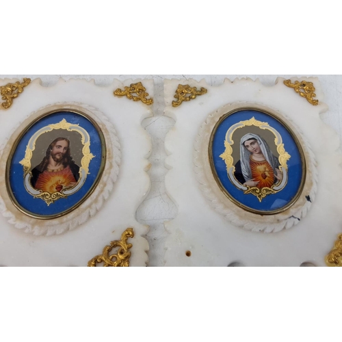 123 - Pair of religious icons in white marble frames with gold detailing, featuring portraits of the Sacre... 